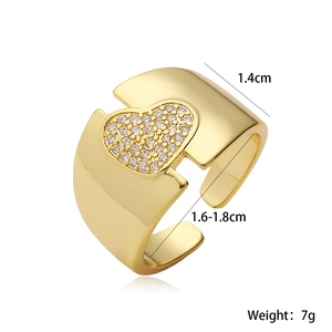 Vintage style gold-plated wide heart ring with zircon stones on white background