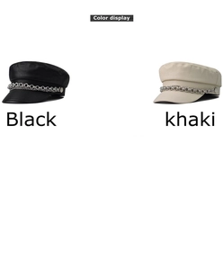 Detail of PU leather baker boy caps in black and khaki with silver chain accents