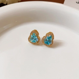 Elegant gold-plated wulu stud earrings with light blue crystals and white zircons