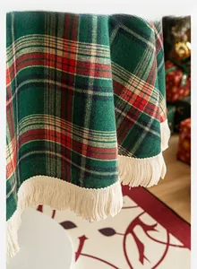 Close-up of red and green plaid tablecloth with thick cream fringe for Christmas decor