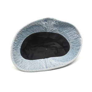 Detail view of light blue washed denim bucket hat with black cotton lining and neat stitching