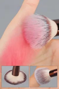 Detailed close-up of dual-ended makeup brush with soft gradient bristles and even powder application