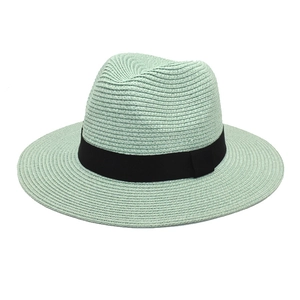 Detail of mint green straw fedora featuring a classic black grosgrain ribbon band