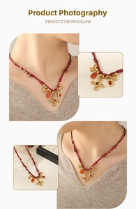 Detailed close-up showing red woven necklace with tiger eye and cross pendants