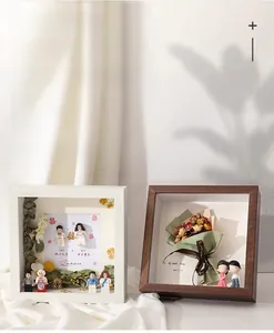 Detail of 5cm deep hollow shadow box frame with miniature dried flowers and figurines