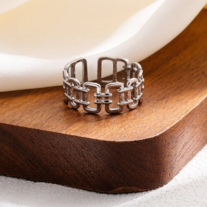 Close-up of vintage multi-layer stainless steel ring with open geometric link design