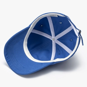 Interior detail of 100% cotton navy baseball cap showing 6-panel stitching and metal buckle
