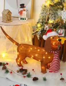 Close-up of lighted Dachshund Christmas decoration with red scarf and warm LED lights