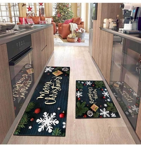 Detailed view of two-piece dark blue Christmas kitchen mats with festive gold lettering