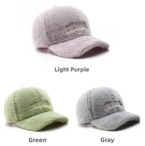 Detail view of plush baseball caps with embroidered COLORIN logo in three pastel colors