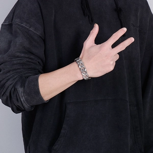 Close-up of men's chunky titanium steel Cuban bracelet with intricate engraved textures