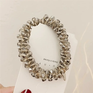 Detailed view of twist design grey crystal beads hair tie on card, Made in Korea