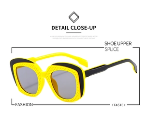 Close-up of bright yellow honeycomb hollow frame and dark lenses on hip-hop sunglasses
