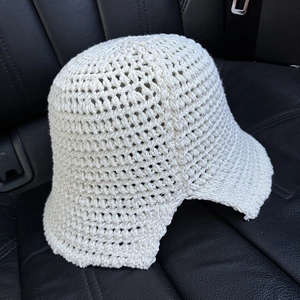 Close-up of cream hollow crochet knit pattern on a summer foldable bucket hat
