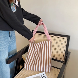 Striped canvas tote bag with pink ruffled handles and brown contrast vertical stripes