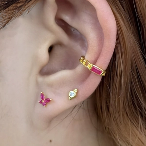 Detail of 925 silver butterfly ear studs and chain cuff with pink marquise stones