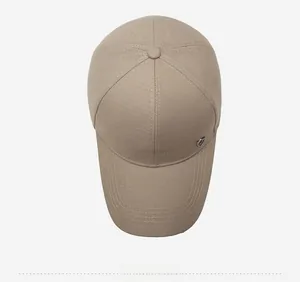 Top view of khaki baseball cap featuring six-panel structure and metal logo detail