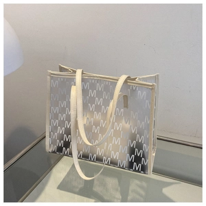 Detail shot of the large capacity cream white tote bag with monogram M pattern