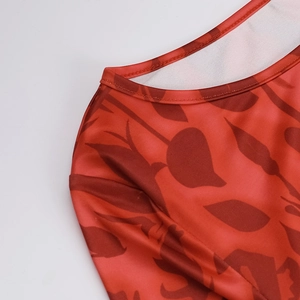 Close-up of the round neckline and stitching on this elegant red floral printed dress
