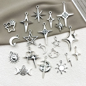 Detailed view of silver alloy star, moon and lightning charms for DIY jewelry making