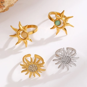 Macro view of sunflower rings with celestial sun and moon designs in gold and silver