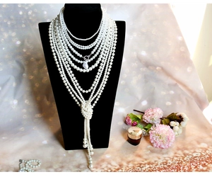 Multi-layer Baroque pearl necklace with irregular pendant shown on a black bust model