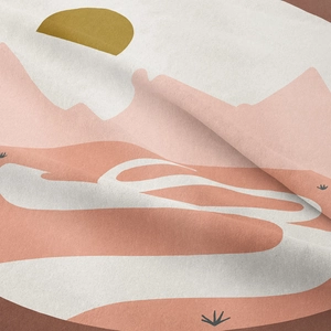 Detailed close-up of woven tapestry fabric featuring abstract desert mountain sunset design