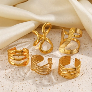 Chic 18K gold plated stainless steel layered cross open rings on minimalist stone display