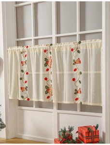 Close-up of American Christmas lace curtain with red bell and green leaf embroidery