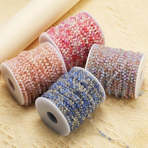 Macro view of four colorful 3mm beaded stainless steel chain rolls for DIY jewelry making