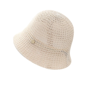 Beige hollow-knit bucket hat for women featuring a minimalist metal logo plate on white background