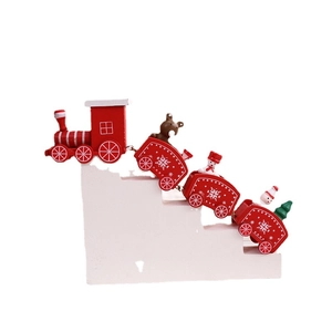 Classic red wooden Christmas train decoration with snowman and Santa figures on white steps