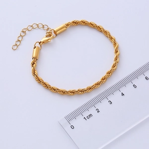 Macro detail of 4mm gold rope chain with lobster clasp and ruler measurement for scale