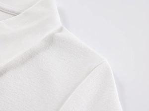 Detailed close-up of white polo shirt collar and fine fabric texture craftsmanship