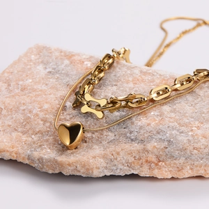 Double-layered golden heart pendant chain necklace with bold link and snake chain design