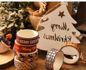 Detail of Christmas washi tape set with gold foil patterns on rustic wood background