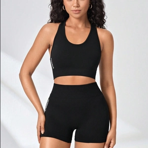 Seamless high-stretch black yoga set with GYMWEAR lettering sports bra and high-waist shorts