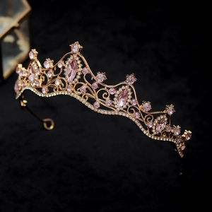 Detail of pink crystal rhinestones on a gold alloy bridal crown with hollow patterns
