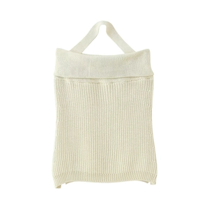 Detailed close-up of cream knit halter top showing refined texture and ribbed pattern