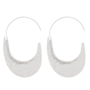 Detailed view of silver hammered texture on large U-shaped statement hook earrings