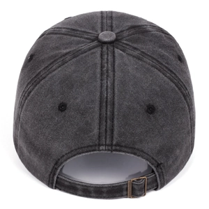 Detail of adjustable metal buckle strap and washed texture on gray baseball cap