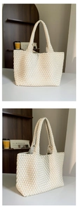 Close-up of the large cream woven leather tote bag with elegant handmade texture