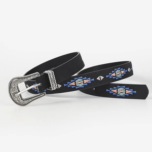 Close-up of black leather belt featuring colorful geometric embroidery and ornate silver buckle