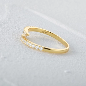 Detailed macro shot of a gold S925 sterling silver ring with sparkling crystal stones