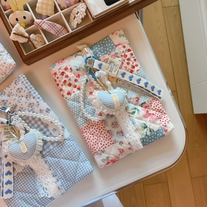 Blue floral quilted cotton pouch with handmade heart charm and lace details