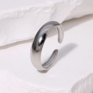 Minimalist silver open ring on white stone background with elegant 18K gold plating