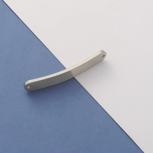Close-up of curved brushed silver titanium steel bar connector with two holes