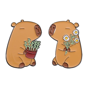 Set of two cartoon capybara enamel pins holding potted plant and white daisy flower