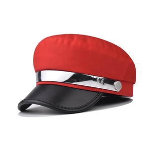 Detail of red and black military hat with silver chain and M letter ornament