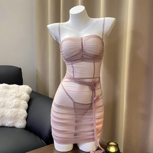 Detail view of pink sheer mesh babydoll dress with pleated fabric and floral waist decor